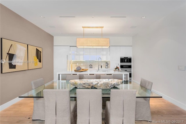 dining area featuring light hardwood / wood-style flooring and sink