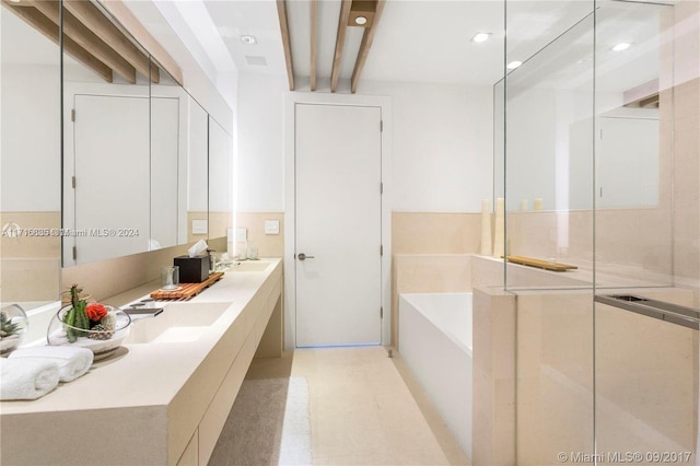 bathroom with a washtub and vanity