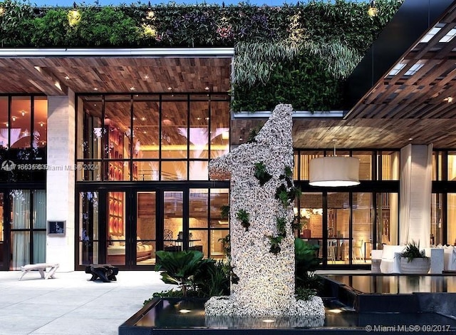 rear view of property featuring french doors