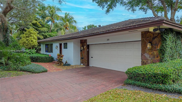 3111 N 52nd Ave, Hollywood, FL 33021 - ranch-style home with stone siding, decorative driveway, a garage, and stucco siding