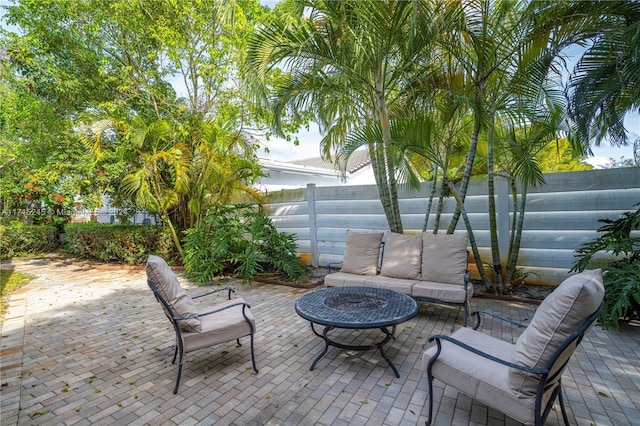 view of patio / terrace featuring an outdoor living space with a fire pit