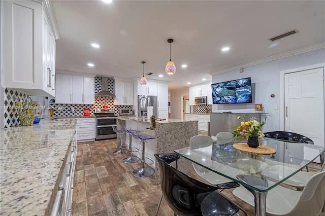 dining area featuring dark hardwood / wood-style flooring and ornamental molding