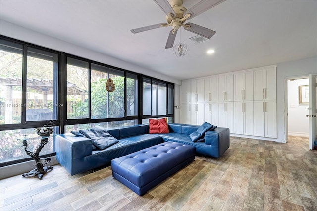 living room featuring ceiling fan and light hardwood / wood-style floors