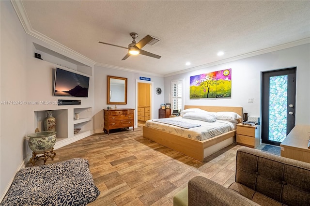 bedroom featuring ceiling fan, light wood-type flooring, a textured ceiling, and ornamental molding