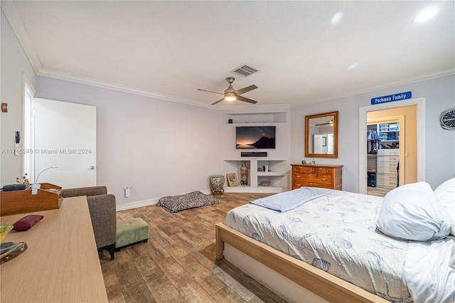 bedroom with ceiling fan, a spacious closet, crown molding, hardwood / wood-style floors, and a closet