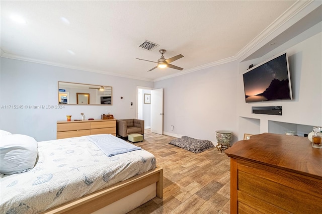 bedroom featuring light hardwood / wood-style flooring, ceiling fan, and ornamental molding