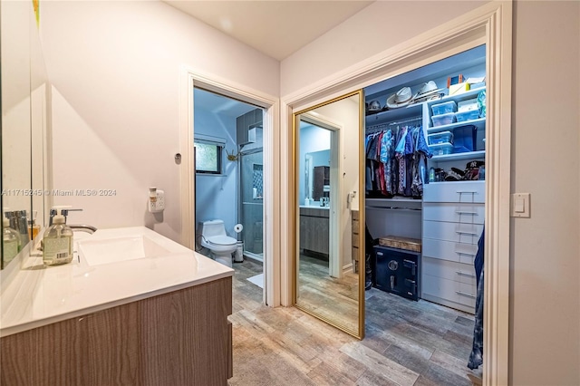3111 N 52nd Ave, Hollywood, FL 33021 - full bathroom featuring wood finished floors, vanity, and a walk in closet