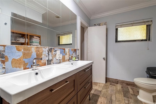 bathroom with vanity, toilet, and ornamental molding