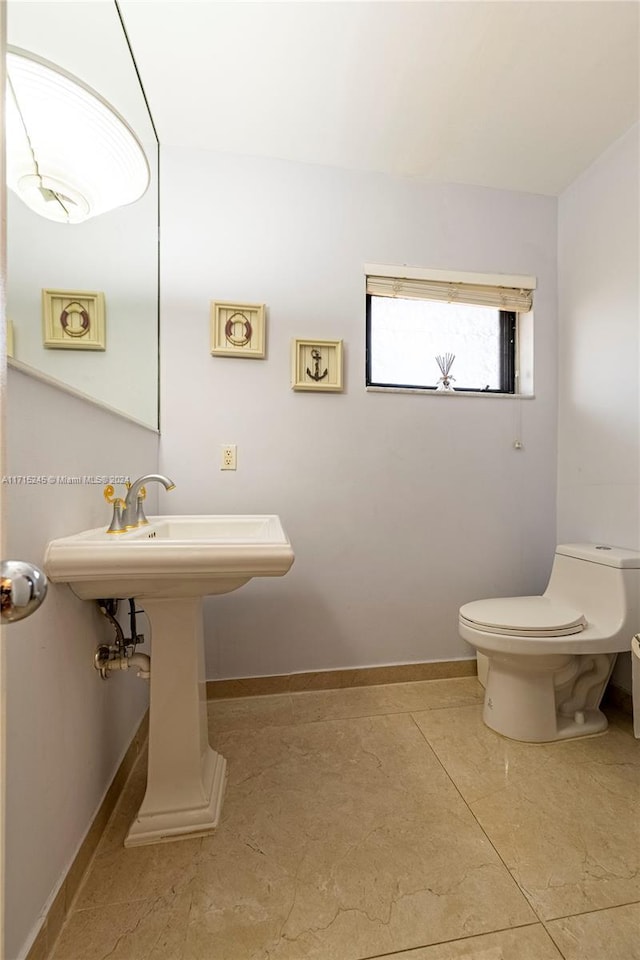 bathroom with tile patterned floors and toilet