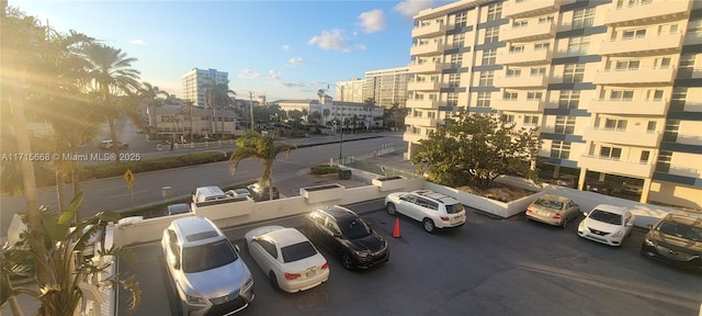 uncovered parking lot featuring a view of city