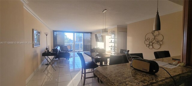 dining room with a wall of windows, ornamental molding, and light tile patterned flooring