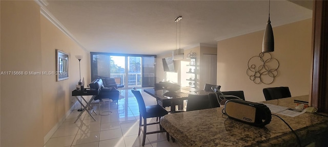 dining space with ornamental molding, a wall of windows, light tile patterned flooring, and baseboards