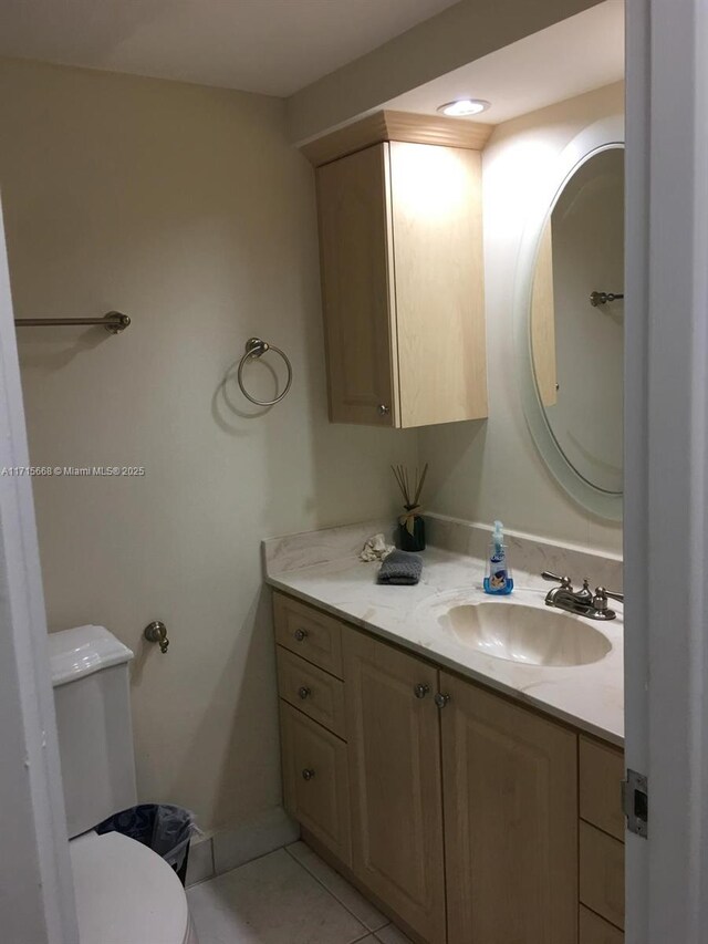 bathroom featuring tile patterned flooring, vanity, and toilet