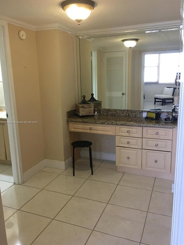 bathroom featuring crown molding, tile patterned flooring, and vanity