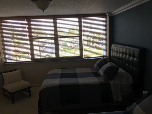 bedroom featuring tile patterned floors and ornamental molding