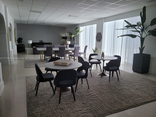 dining space with a drop ceiling