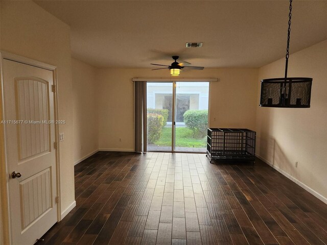 unfurnished room featuring ceiling fan and dark hardwood / wood-style flooring