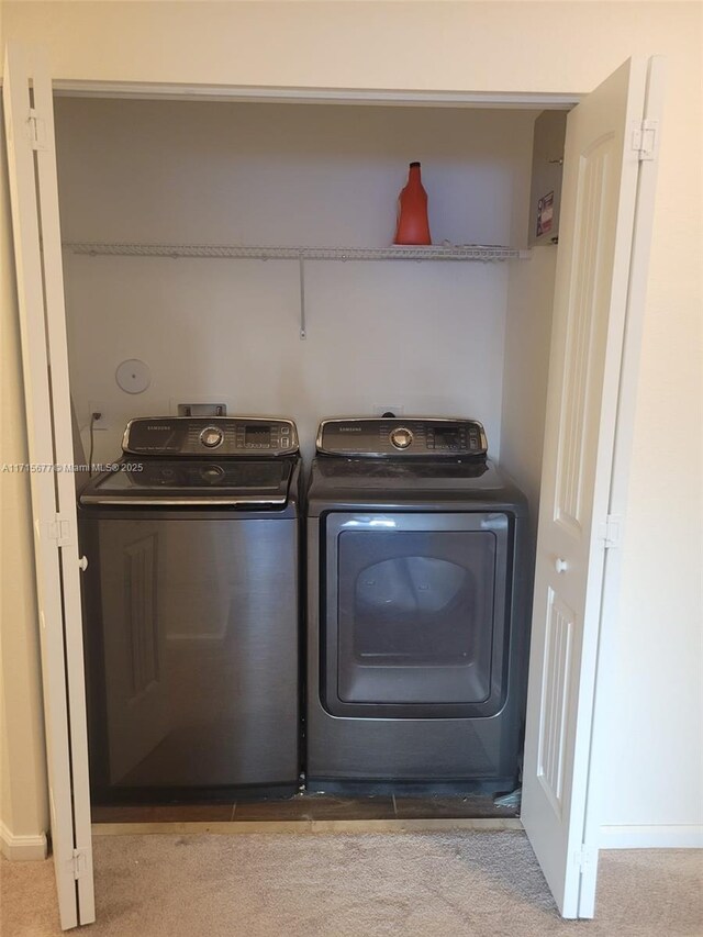 laundry room featuring carpet and separate washer and dryer