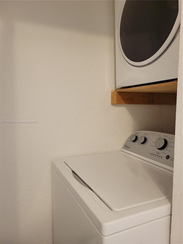 washroom with stacked washer and dryer