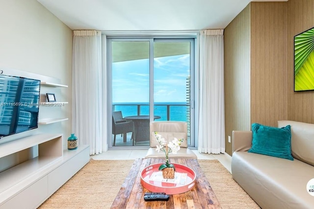 living room with a water view and floor to ceiling windows