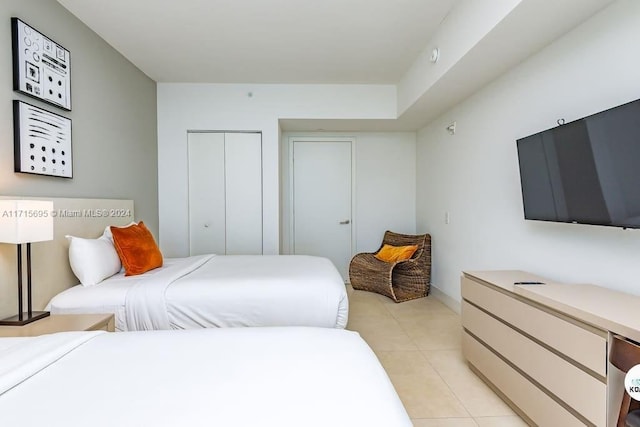 tiled bedroom featuring a closet