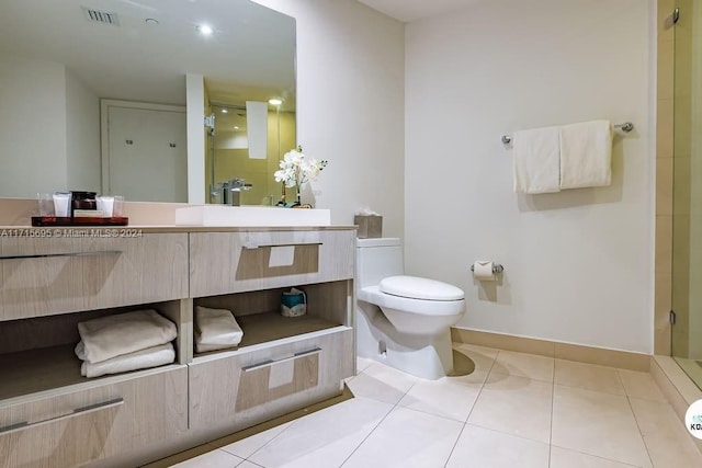 bathroom with tile patterned flooring, vanity, toilet, and a shower with shower door