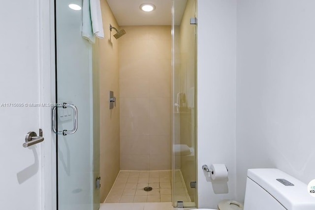 bathroom featuring toilet and an enclosed shower