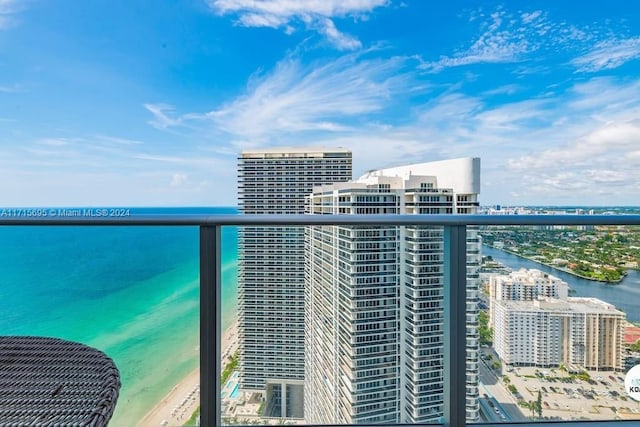 balcony featuring a water view and a view of the beach