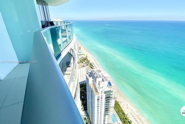 exterior space with a water view and a beach view