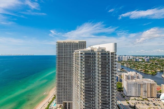 drone / aerial view with a water view and a beach view