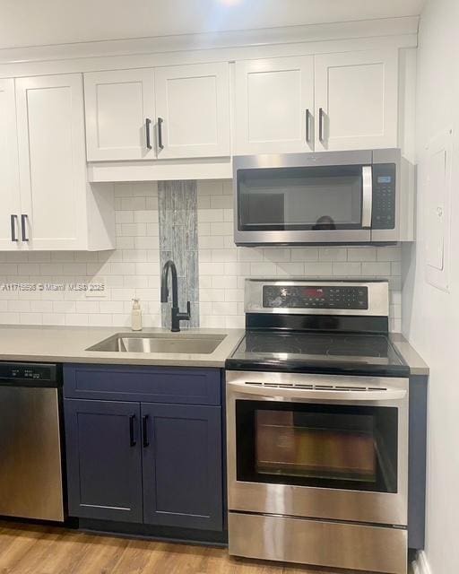 kitchen featuring white cabinetry, appliances with stainless steel finishes, and sink