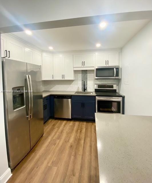 kitchen with white cabinetry, appliances with stainless steel finishes, and sink