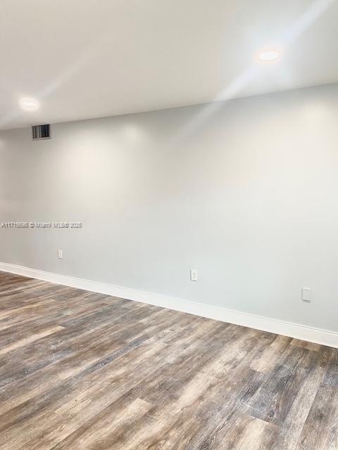 empty room featuring dark hardwood / wood-style flooring