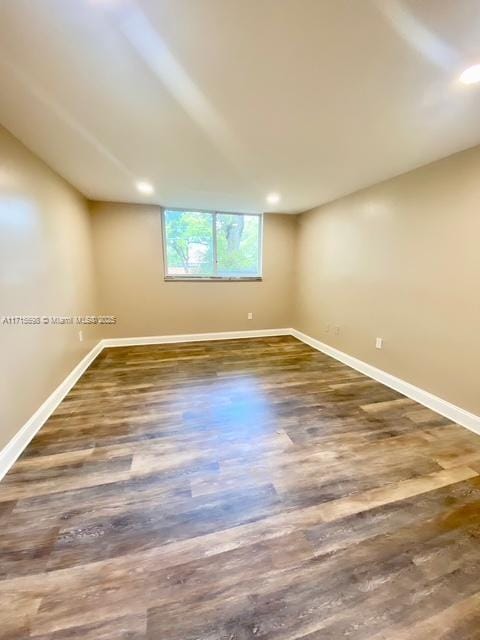 spare room with dark wood-type flooring