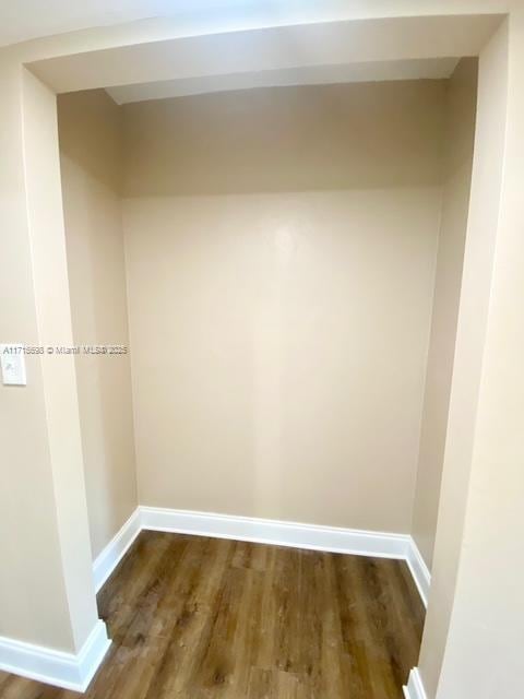 unfurnished room featuring dark wood-type flooring