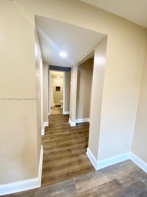 corridor with dark wood-type flooring