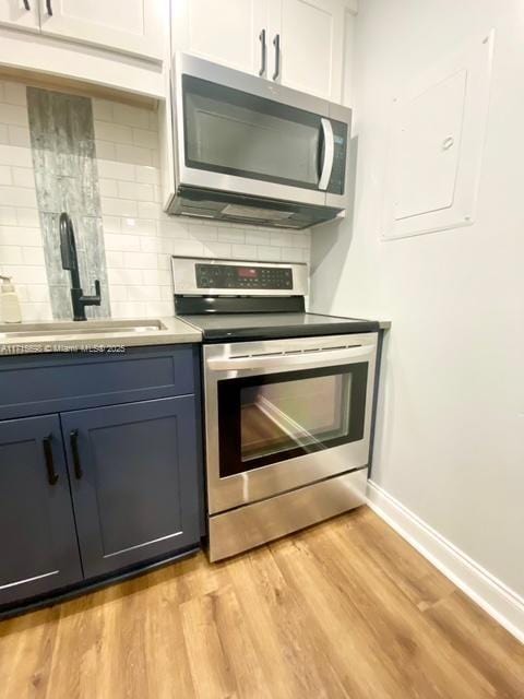 kitchen featuring white cabinetry, sink, tasteful backsplash, and appliances with stainless steel finishes