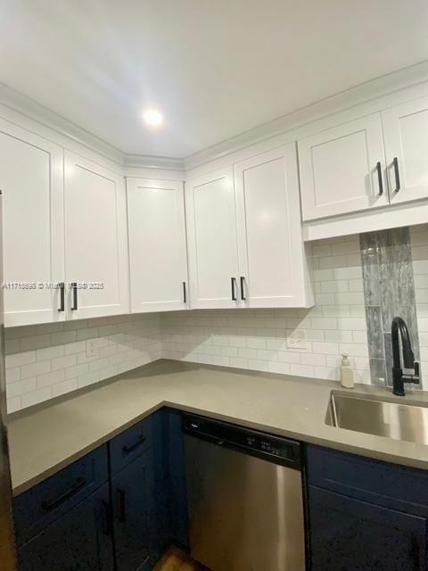 kitchen with sink, blue cabinetry, dishwasher, tasteful backsplash, and white cabinets