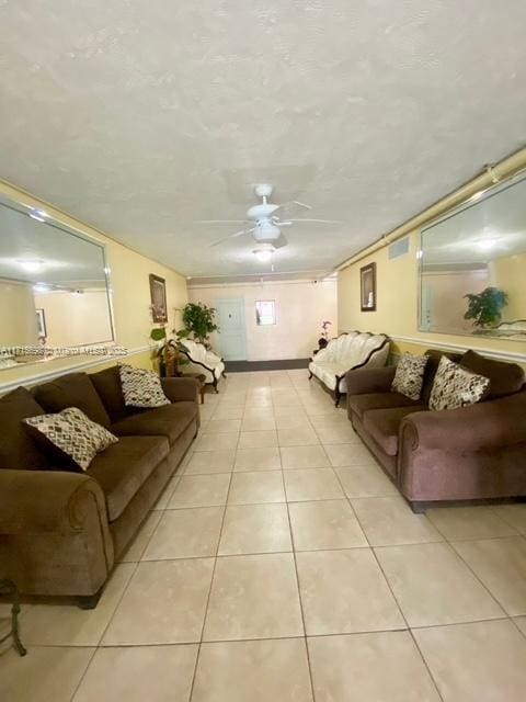 living room featuring ceiling fan and light tile patterned floors