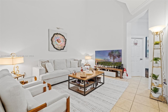 tiled living room with high vaulted ceiling and ornamental molding