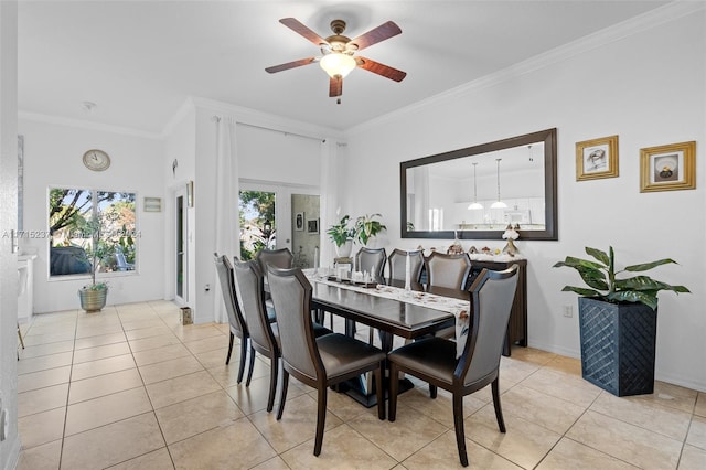 tiled dining room with crown molding and ceiling fan