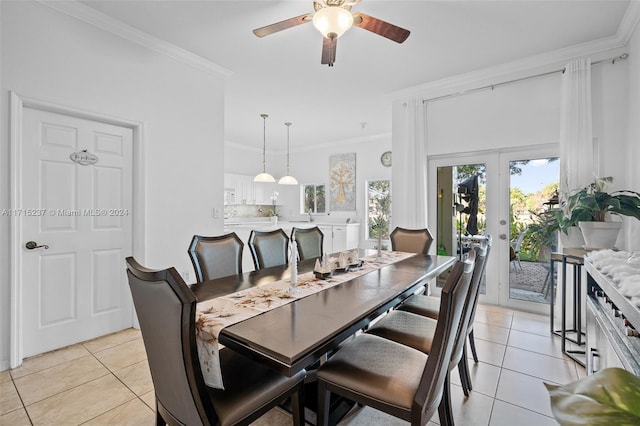 dining room with french doors, light tile patterned floors, ceiling fan, and ornamental molding