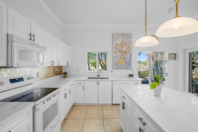 kitchen with white appliances, white cabinets, sink, hanging light fixtures, and light stone counters