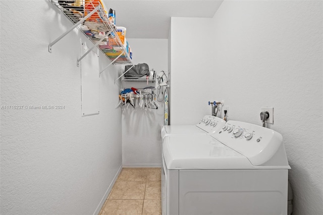 laundry room with separate washer and dryer and light tile patterned floors