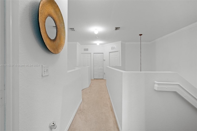 corridor featuring light carpet and crown molding