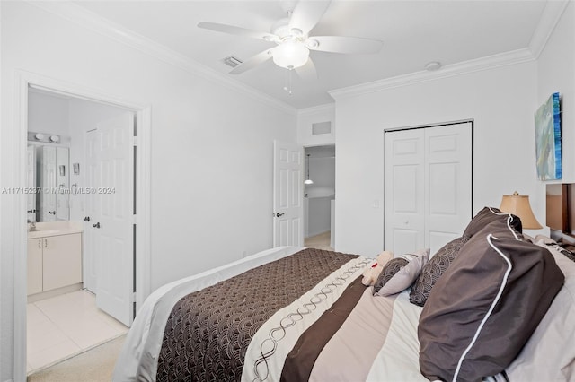 bedroom featuring crown molding, ensuite bath, ceiling fan, light tile patterned floors, and a closet