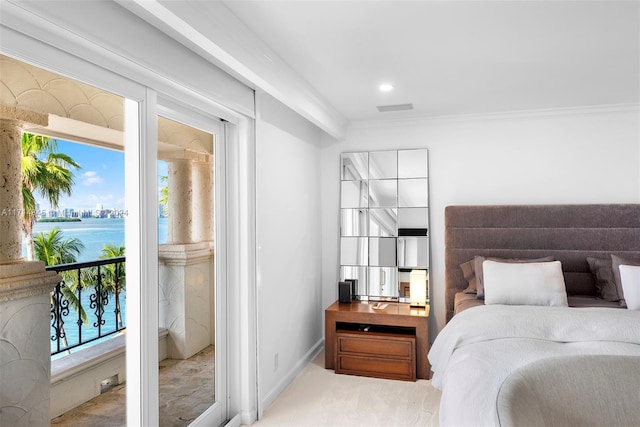 bedroom with a water view and ornamental molding