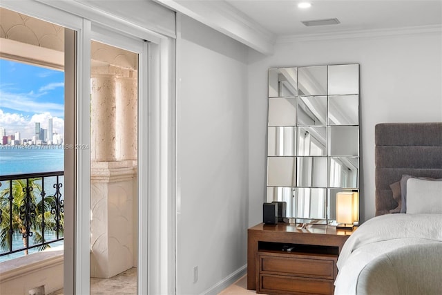 bedroom featuring a water view and ornamental molding