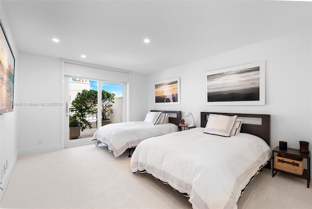 bedroom with access to exterior and light colored carpet