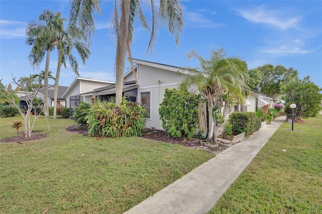 view of property exterior featuring a lawn